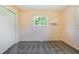 This bedroom features neutral walls, gray carpeting, and a bright window at 1171 S Daisy Ln, New Palestine, IN 46163