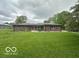 A charming single-story brick home features a well-maintained lawn and classic design elements at 1171 S Daisy Ln, New Palestine, IN 46163