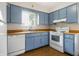 Functional kitchen with blue cabinetry, updated appliances, and ample counter space at 1171 S Daisy Ln, New Palestine, IN 46163