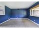 Spacious living room features neutral carpeting, fresh paint, and a bright window at 1171 S Daisy Ln, New Palestine, IN 46163