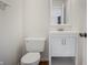 Well-lit powder room featuring a modern vanity with a white countertop and a mirror at 1171 S Daisy Ln, New Palestine, IN 46163
