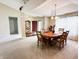 Open floor plan dining room showcases a wood table, cabinet, chandelier, and natural light at 11821 Bills Ave, Fishers, IN 46037