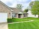 Inviting home with lush green lawn, brick facade, and charming front porch at 11821 Bills Ave, Fishers, IN 46037