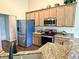 Kitchen with stainless steel appliances, granite countertops, and wooden cabinetry at 11821 Bills Ave, Fishers, IN 46037