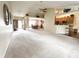 Spacious living room featuring a ceiling fan, neutral paint, and a view of the entryway and dining area at 11821 Bills Ave, Fishers, IN 46037