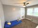 Bedroom with gray walls, ceiling fan, and a door to another room at 125 Howard St, Greenfield, IN 46140