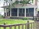 Charming home with a covered front porch, wooden railings, and a well-maintained lawn at 125 Howard St, Greenfield, IN 46140