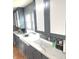 Bright kitchen featuring gray cabinetry, undermount sink, stylish backsplash and quartz countertops at 125 Howard St, Greenfield, IN 46140