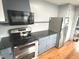 Kitchen featuring stainless steel appliances, gray cabinets and black countertop at 125 Howard St, Greenfield, IN 46140