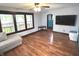 Spacious living room featuring gleaming hardwood floors and an abundance of natural light from large windows at 125 Howard St, Greenfield, IN 46140