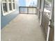 Cozy screened-in porch with concrete flooring, perfect for relaxing and enjoying the outdoors at 125 Howard St, Greenfield, IN 46140