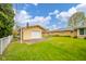 The backyard features a garage and a well-manicured lawn, offering ample space and a clean aesthetic at 1324 Chesterfield Dr, Anderson, IN 46012