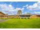 Large backyard with a sunroom and well-kept lawn at 1324 Chesterfield Dr, Anderson, IN 46012