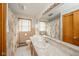 Bathroom featuring a large mirror, cabinet with sink, toilet and a shower with curtain at 1324 Chesterfield Dr, Anderson, IN 46012