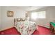 Bright bedroom with a large window, white walls, and a plush bed with decorative pillows at 1324 Chesterfield Dr, Anderson, IN 46012
