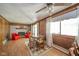 A dining room with wood paneled walls and an area rug below the table at 1324 Chesterfield Dr, Anderson, IN 46012