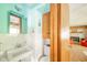 A vintage half bathroom with a white sink, toilet, and cabinet at 1324 Chesterfield Dr, Anderson, IN 46012