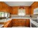 Traditional kitchen featuring wood cabinets, white countertops, and practical tiled flooring at 1324 Chesterfield Dr, Anderson, IN 46012