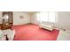 Bright living room offering classic furnishings, large windows, and cozy pink carpeting at 1324 Chesterfield Dr, Anderson, IN 46012