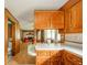 Kitchen featuring wood cabinets, white countertops leading into the living room at 1324 Chesterfield Dr, Anderson, IN 46012