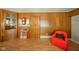 Living room with paneled walls and a red chair at 1324 Chesterfield Dr, Anderson, IN 46012