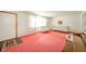 Inviting living room with classic furniture, pink carpeting, and ample natural light at 1324 Chesterfield Dr, Anderson, IN 46012