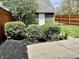 Backyard with a shed and a privacy fence surrounded by mature bushes at 1328 Sturm Ave, Indianapolis, IN 46202