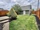 Well-maintained backyard featuring green lawn, wooden fence, and a small shed for extra storage at 1328 Sturm Ave, Indianapolis, IN 46202