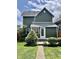 Home backyard featuring lush green grass, mature trees, and access to the back entrance at 1328 Sturm Ave, Indianapolis, IN 46202