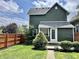 Spacious backyard features lush green grass, privacy fencing, and an entrance into the home at 1328 Sturm Ave, Indianapolis, IN 46202