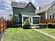 Backyard with green grass, mature bushes, and a privacy fence for the home at 1328 Sturm Ave, Indianapolis, IN 46202