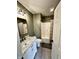 Bathroom with marble countertop vanity, tiled floors, and shower-tub combo with tan shower curtain at 1328 Sturm Ave, Indianapolis, IN 46202