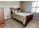 Comfortable bedroom featuring a cherry-wood style bed and neutral-colored walls at 1328 Sturm Ave, Indianapolis, IN 46202