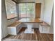 A bright breakfast nook features a built-in wraparound bench and wood table at 1328 Sturm Ave, Indianapolis, IN 46202
