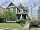Charming two-story home with dark green siding, a turret design, and a well-maintained lawn at 1328 Sturm Ave, Indianapolis, IN 46202