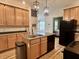 Kitchen featuring a central island with a stainless sink and modern lighting at 1328 Sturm Ave, Indianapolis, IN 46202
