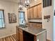 Kitchen showcasing a central island with a stainless sink and contemporary pendant lighting at 1328 Sturm Ave, Indianapolis, IN 46202