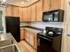 Well-lit kitchen features wood cabinets, modern appliances, and a practical layout at 1328 Sturm Ave, Indianapolis, IN 46202
