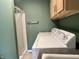 The laundry room also includes a shower and cabinetry above the washer and dryer at 1328 Sturm Ave, Indianapolis, IN 46202