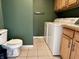 The laundry room also serves as a partial bathroom with a toilet at 1328 Sturm Ave, Indianapolis, IN 46202