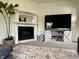 Stylish living room with fireplace, TV, and decorative shelving, perfect for cozy nights at 1328 Sturm Ave, Indianapolis, IN 46202