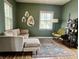 Bright living room featuring a comfortable sofa and two windows, creating a relaxing atmosphere at 1328 Sturm Ave, Indianapolis, IN 46202