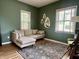 Cozy living room with a plush sofa, hardwood floors and two windows at 1328 Sturm Ave, Indianapolis, IN 46202