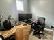 Well-lit office space featuring a desk with two monitors, and two comfortable chairs at 1328 Sturm Ave, Indianapolis, IN 46202