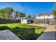 Backyard featuring a shed, fire pit, grass, and a wooden fence on a sunny day at 139 N East St, Pendleton, IN 46064