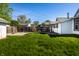 Spacious backyard with green grass, wooden fence, and view of neighboring houses, ideal for outdoor activities at 139 N East St, Pendleton, IN 46064