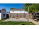 Backyard with a fire pit, wooden fence, grass, and trees, perfect for outdoor relaxation at 139 N East St, Pendleton, IN 46064