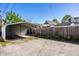 Backyard featuring a carport and wooden fence on a sunny day at 139 N East St, Pendleton, IN 46064