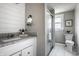 Bathroom featuring white cabinets, granite countertop, and a shower with a glass door at 139 N East St, Pendleton, IN 46064