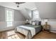 Attic bedroom featuring a Queen bed, hardwood floors, and bright, natural light at 139 N East St, Pendleton, IN 46064